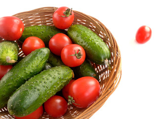 cucumbers and tomatoes in a wicker basket