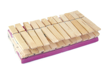 Set of new and unopen wooden cloth pegs or pins on a white