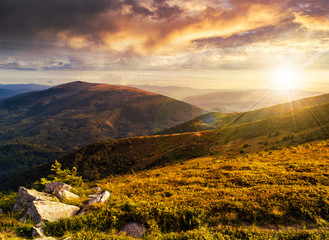 hillside with stones in high mountains at sunset