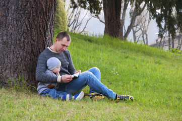dad and son reading a book