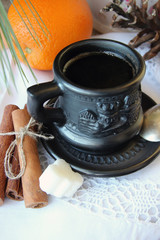 A cup of coffee and orange .