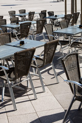 Beach view of a coffee terrace with tables and chairs