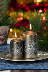 Closeup of colored Christmas candles on colored background
