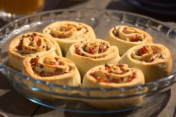 Baked homemade rolls filled with tomato, ham and herbs