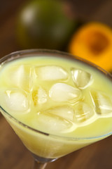 Peruvian cream liqueur made of lucuma fruit with ice cubes