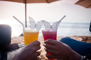 honeymoon couple lying at sunbed near the blue ocean