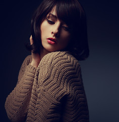 Beautiful woman with short hair in warm cardigan. Art closeup