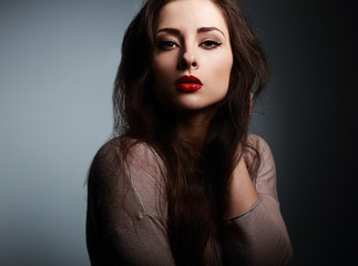 Sexy makeup woman with red lipstick looking on dark