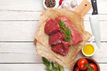 Raw fillet beef steak and spices on wooden table. Top view