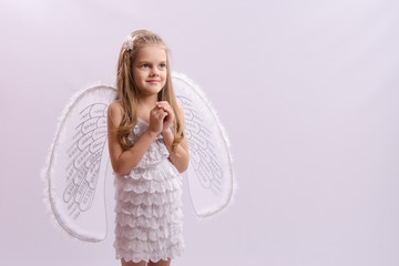 girl dressed as an angel with wings folded hands