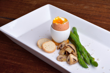 Egg, mushrooms, asparagus, croutons and gray salt