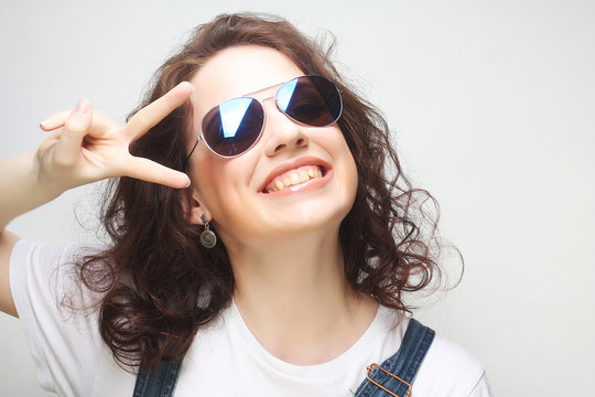 Young surprised woman wearing sunglasses.