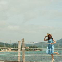 Young happy woman posing near sea