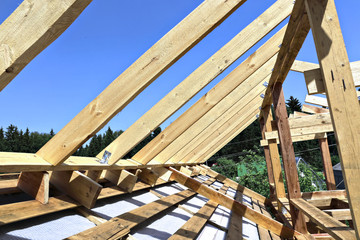 Installation of wooden beams at construction the roof truss syst