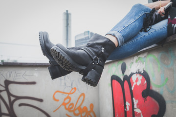 Detail of a young woman wearing biker boots