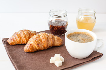 Breakfast with croissant and cup of coffee