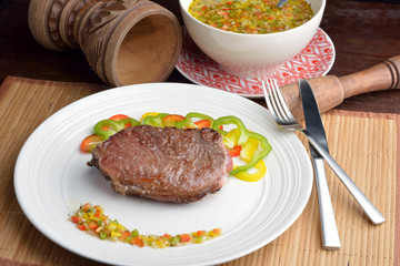 .steak with vinaigrette: sweet pepper, onion and tomato