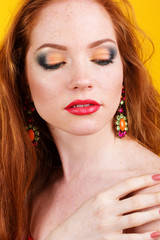 Beautiful redheaded girl with colorful earrings