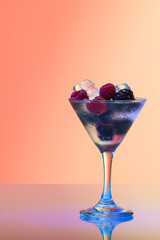 Raspberry and blackberry cocktail with ice, studio shot