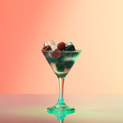 Raspberry and blackberry cocktail with ice, studio shot