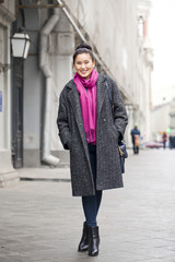 Fototapeta premium Young Asian woman walking on spring city in Russia