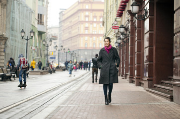Young Asian woman walking on spring city in Russia