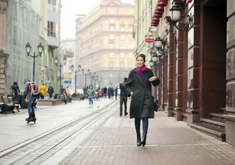 Young Asian woman walking on spring city in Russia