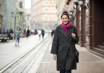 Obraz premium Young Asian woman walking on spring city in Russia