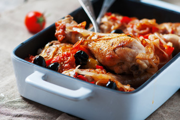 Cooked chicken with tomato, onion, pepper and olive