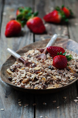 Homemade muesli with strawberry on the wooden table