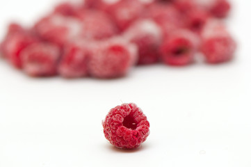 Frozen raspberries on white