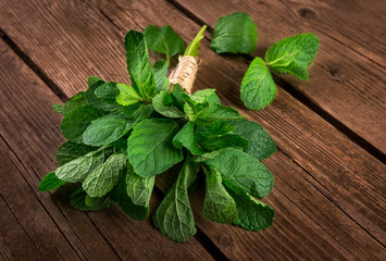 Bunch of mint on the wooden background