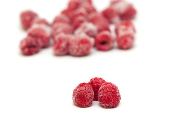 Frozen raspberries on white