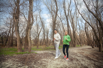 Fototapeta premium Two young people jogging in nature