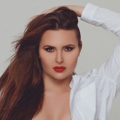 Portrait of beautiful plus size curly young woman