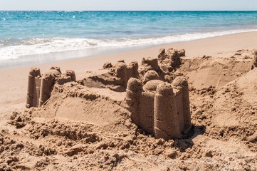 Fototapeta na wymiar Sand castle on the sea shore