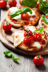 Mini pizza with mozzarella and tomato
