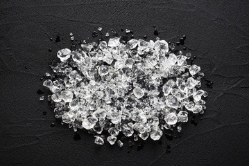 Crushed ice on black stone table top view
