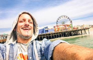 Handsome man taking a selfie at Santa Monica pier in California