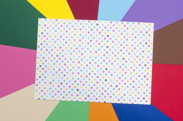 White sheet paper with stars.Craft paper on rainbow background.