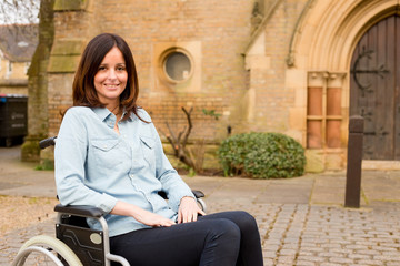 young woman in a wheelchair outside a church