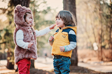 happy toddler friends playing in sunny forest