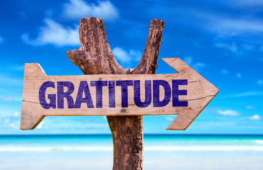 Gratitude sign with a beach on background