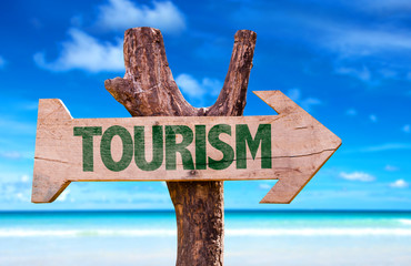 Tourism sign with a beach on background
