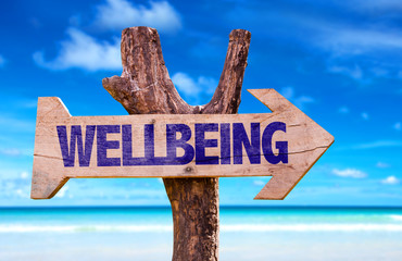 Wellbeing sign with a beach on background