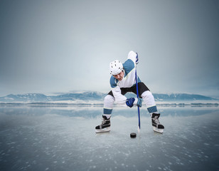 Fototapeta na wymiar Face-off ice hockey moment on the frozen lake