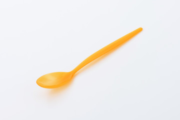 Orange plastic spoon
