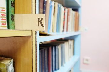 Books in a row. Bookshelf in public library.