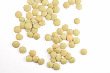 Green lentils on a white background.