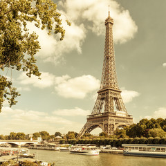 Fototapeta na wymiar View of Eiffel tower from Seine river in Paris, France. Vintage style photo.